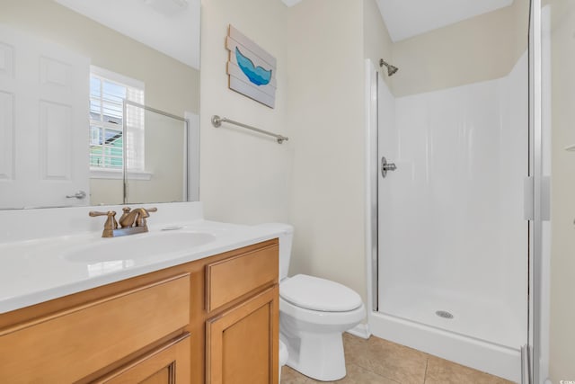 full bath with a stall shower, vanity, toilet, and tile patterned floors