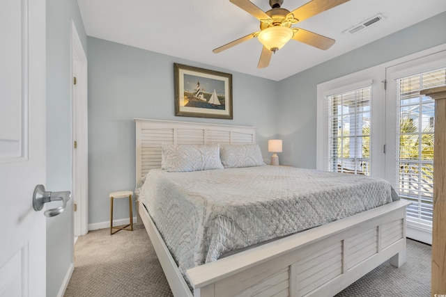 bedroom with light carpet, a ceiling fan, baseboards, visible vents, and access to exterior