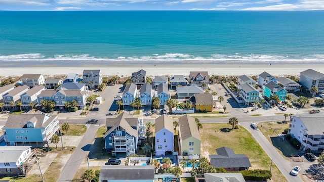 birds eye view of property with a residential view, a water view, and a beach view