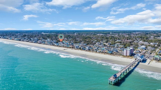 birds eye view of property featuring a water view and a beach view