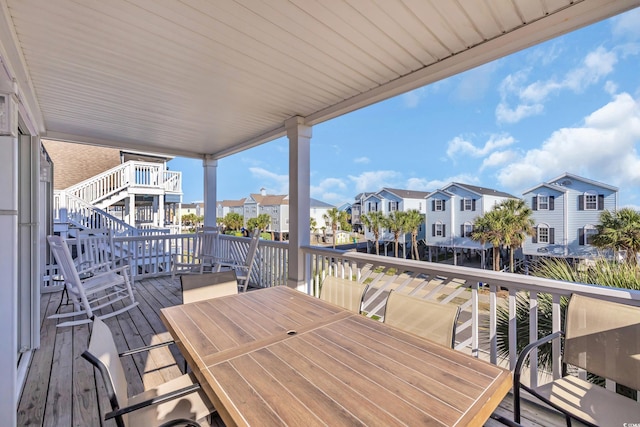 wooden deck featuring outdoor dining space and a residential view