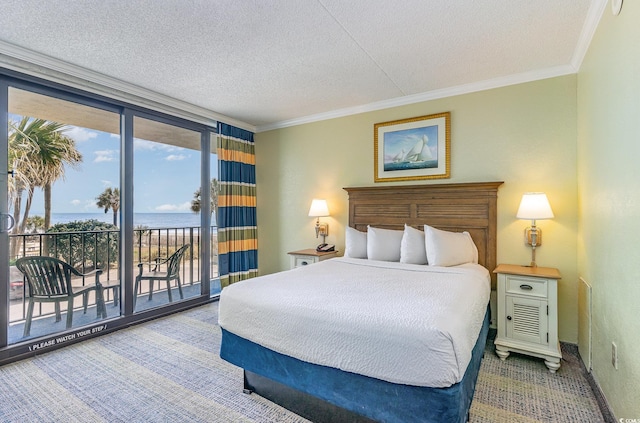 bedroom with a textured ceiling, carpet flooring, access to outside, ornamental molding, and expansive windows