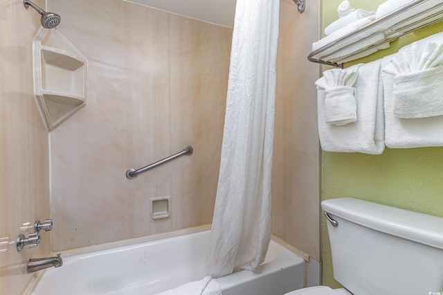 bathroom featuring shower / bathtub combination with curtain and toilet