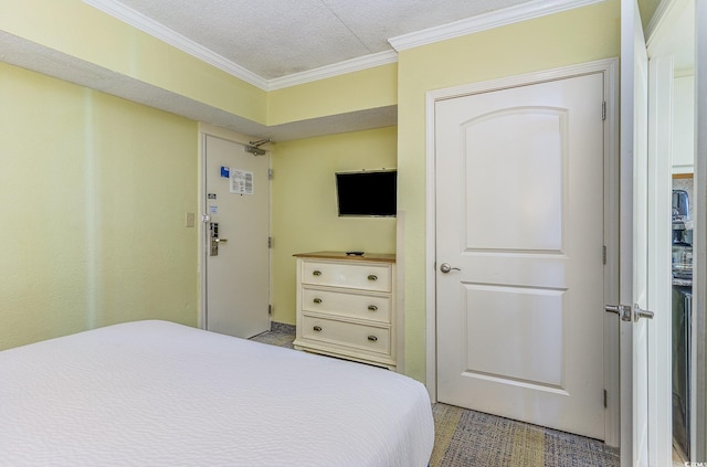 bedroom with crown molding and a textured ceiling