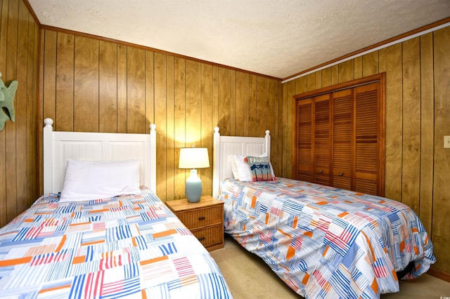 bedroom featuring carpet floors, a closet, wood walls, and a textured ceiling