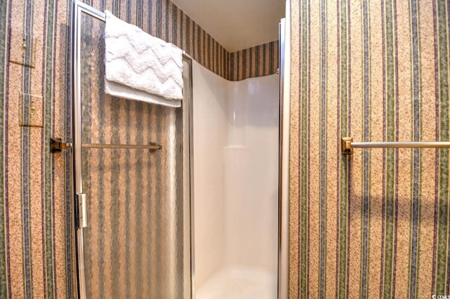 full bath featuring wallpapered walls and a shower