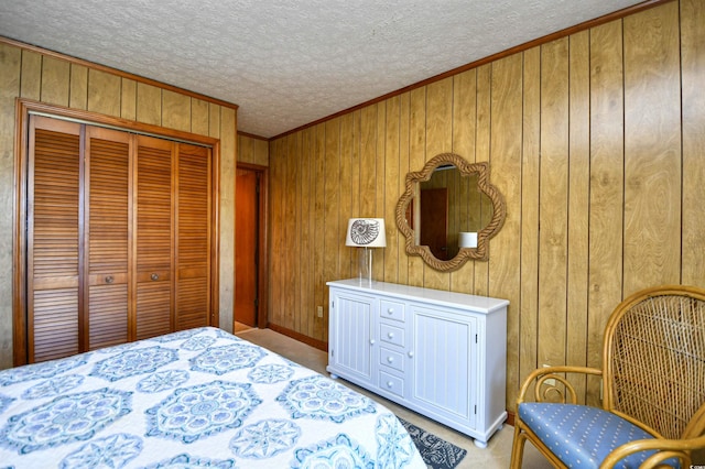 bedroom with wooden walls, a closet, a textured ceiling, and carpet flooring