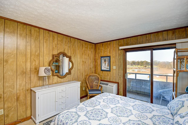 bedroom with a wall unit AC, access to outside, wooden walls, and a textured ceiling