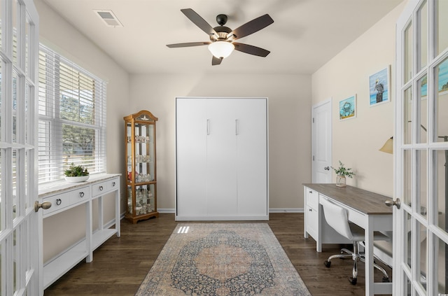 home office featuring a ceiling fan, visible vents, baseboards, french doors, and dark wood finished floors