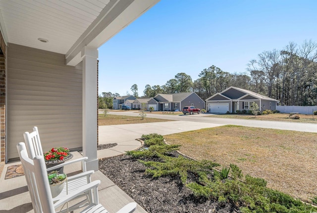 view of yard featuring fence and a residential view