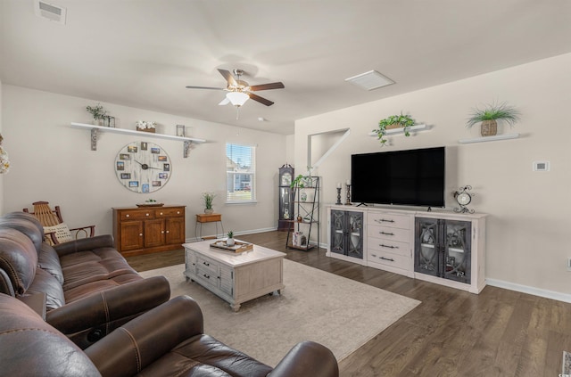 living room featuring baseboards, dark wood-type flooring, visible vents, and a ceiling fan