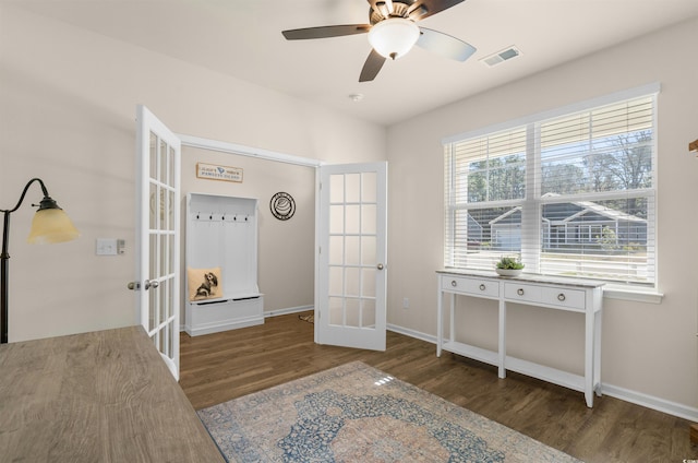 bedroom with baseboards, visible vents, a ceiling fan, wood finished floors, and french doors