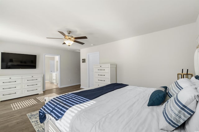 bedroom with connected bathroom, wood finished floors, a ceiling fan, and baseboards