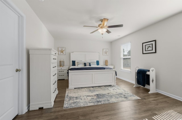 bedroom with ceiling fan, dark wood-type flooring, and baseboards