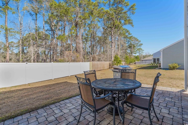 view of patio / terrace with a fenced backyard, a grill, and outdoor dining space