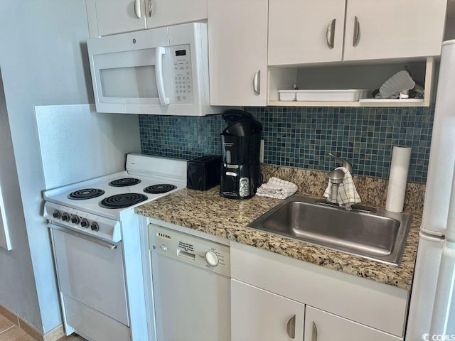 kitchen with white appliances, a sink, white cabinetry, backsplash, and open shelves