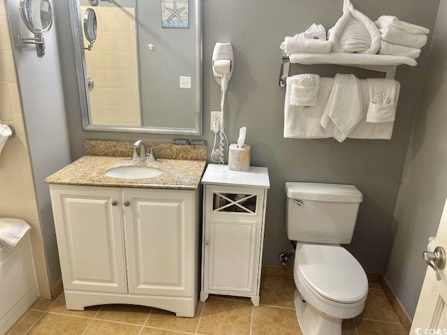 bathroom featuring vanity, tile patterned flooring, and toilet