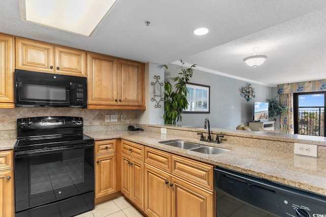 kitchen featuring black appliances, a sink, light stone counters, tasteful backsplash, and light tile patterned flooring