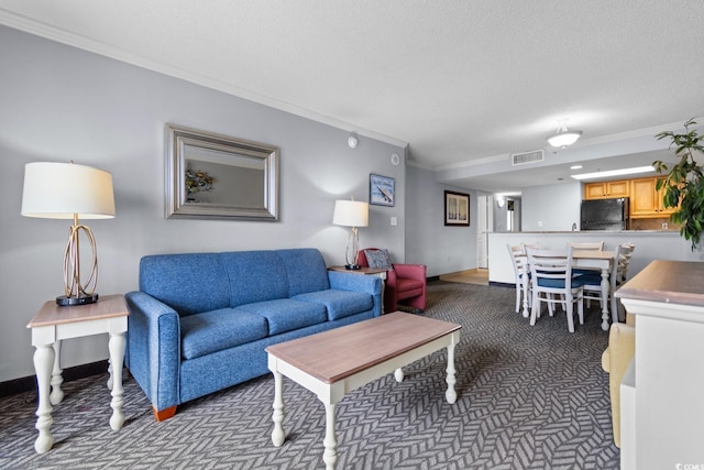 living room featuring visible vents, ornamental molding, a textured ceiling, and dark colored carpet