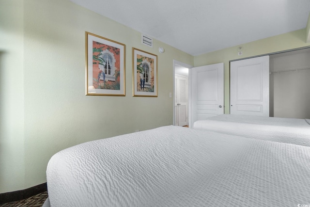 bedroom with visible vents and a closet