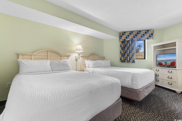 bedroom featuring dark colored carpet