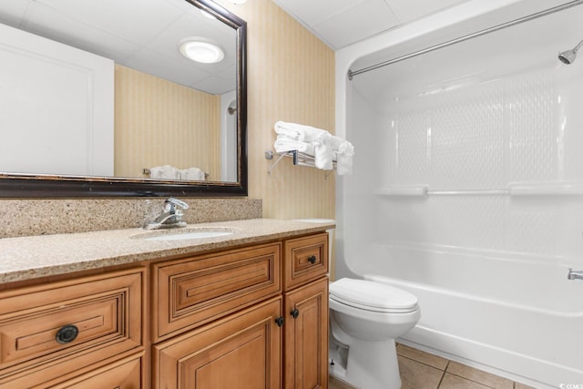 bathroom with tile patterned flooring, tub / shower combination, wallpapered walls, toilet, and vanity