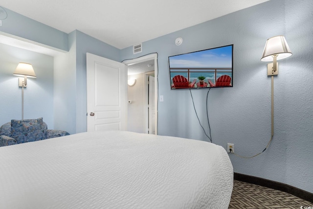 carpeted bedroom with visible vents and baseboards