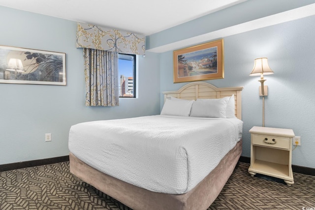 bedroom with baseboards and carpet flooring