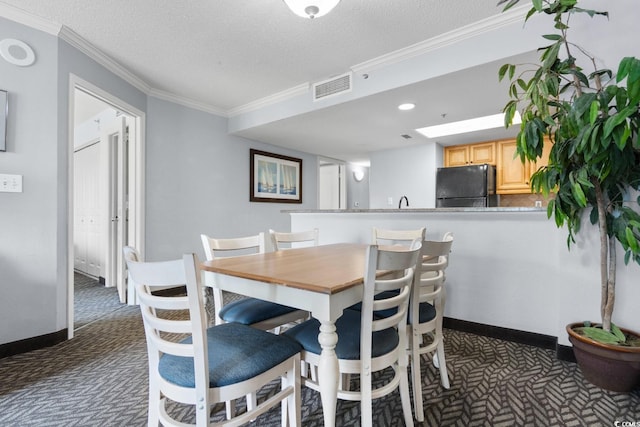 dining area with visible vents, crown molding, baseboards, dark carpet, and a textured ceiling