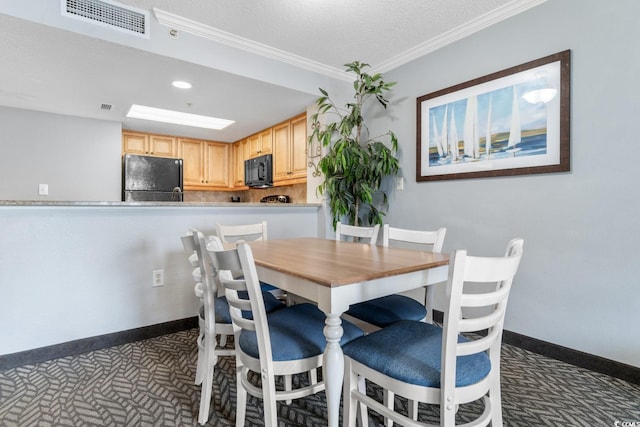 carpeted dining area featuring baseboards, visible vents, recessed lighting, a textured ceiling, and crown molding