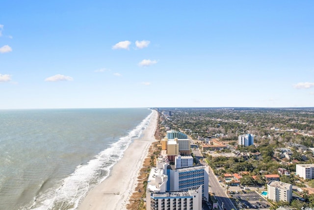 birds eye view of property with a water view, a view of city, and a beach view