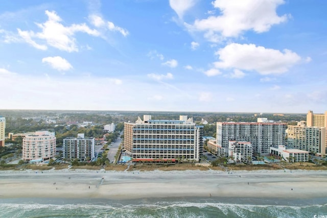 bird's eye view with a water view, a view of city, and a view of the beach