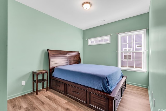 bedroom featuring light wood-type flooring and baseboards