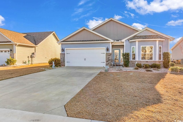 craftsman-style home with a garage, driveway, and brick siding