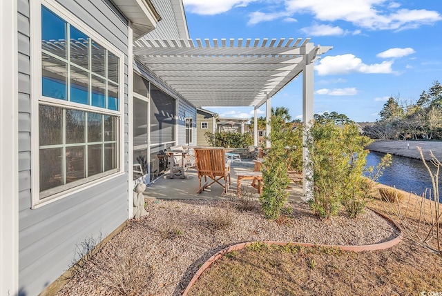 view of patio with a water view and a pergola