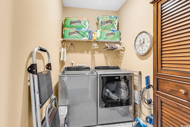 washroom featuring laundry area and washing machine and clothes dryer