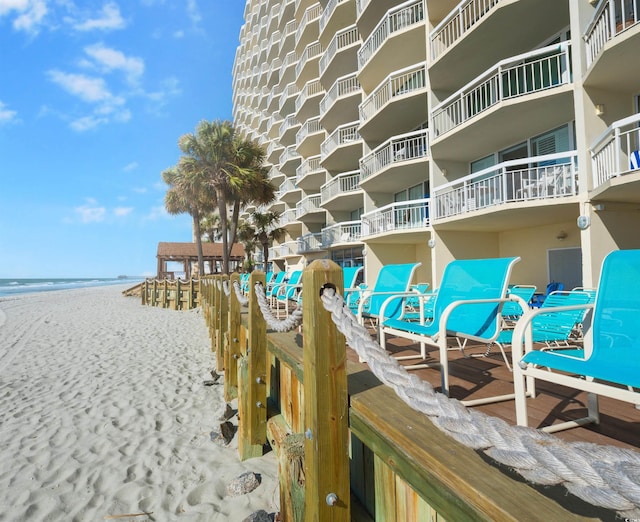 surrounding community featuring a water view and a beach view