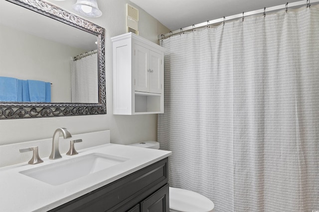 full bathroom featuring vanity and toilet