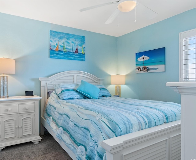 bedroom featuring dark colored carpet and a ceiling fan