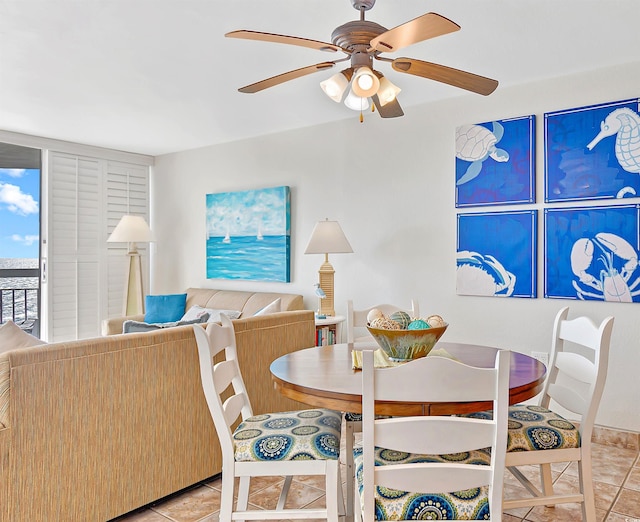 dining space with ceiling fan and light tile patterned flooring