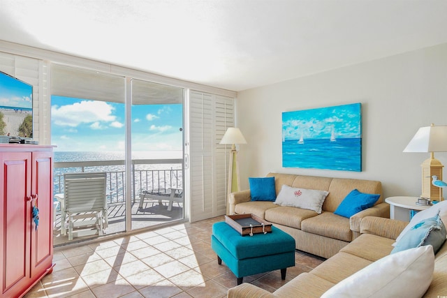 living room featuring expansive windows and light tile patterned floors