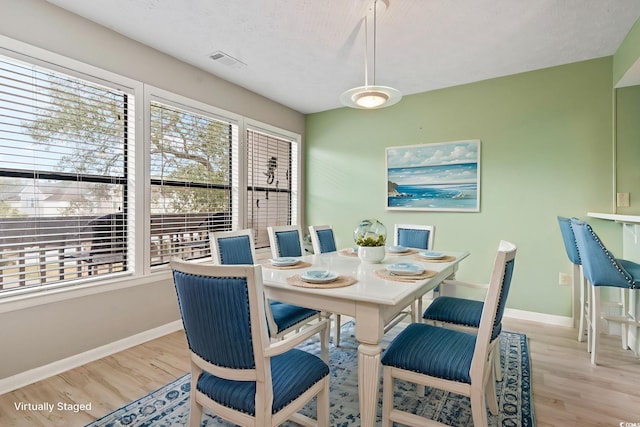310 5th Ave N Unit 206, Surfside Beach, SC 29575 - dining space featuring light wood-type flooring and baseboards