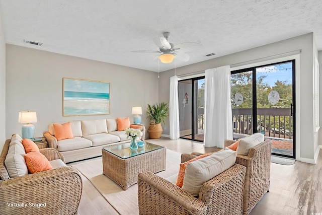 310 5th Ave N Unit 206, Surfside Beach, SC 29575 - living area featuring a ceiling fan, light wood-style flooring, and baseboards