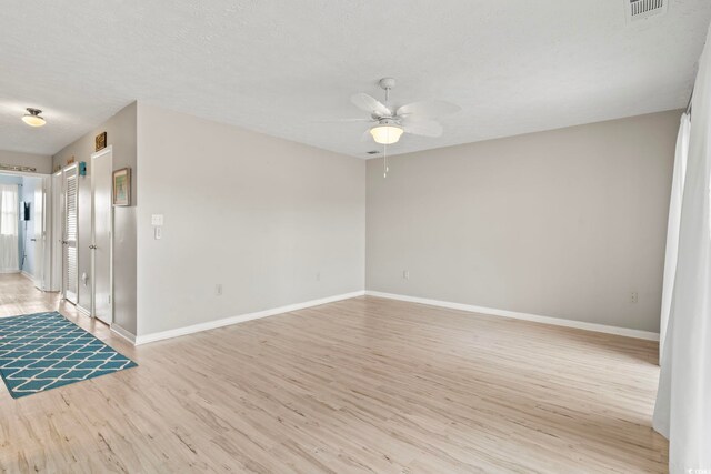 310 5th Ave N Unit 206, Surfside Beach, SC 29575 - empty room featuring light wood-style flooring, a ceiling fan, and baseboards