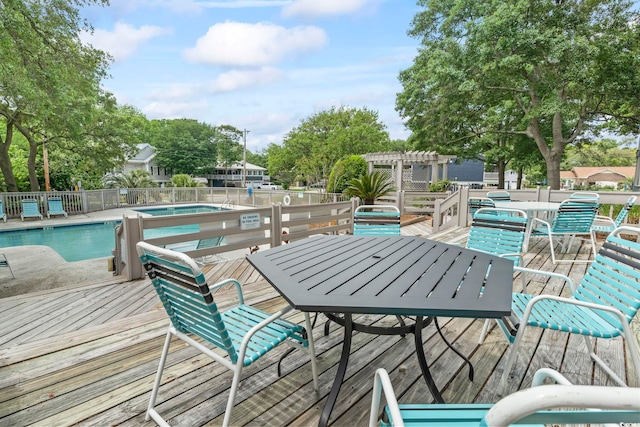 310 5th Ave N Unit 206, Surfside Beach, SC 29575 - wooden terrace featuring a pergola, a hot tub, a community pool, and outdoor dining area