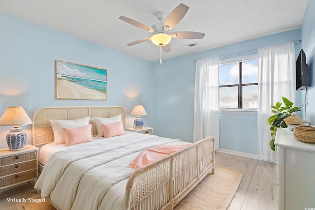 310 5th Ave N Unit 206, Surfside Beach, SC 29575 - bedroom with light wood-style flooring, a ceiling fan, and baseboards
