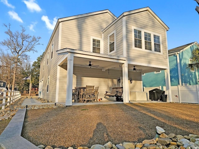 exterior space with a ceiling fan, a patio, and fence