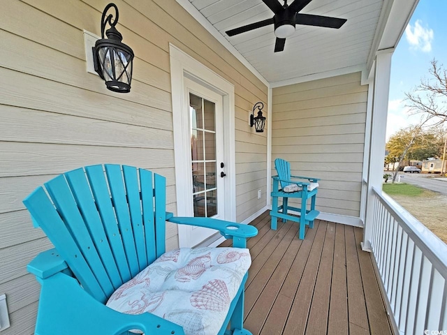 wooden deck featuring a ceiling fan and covered porch