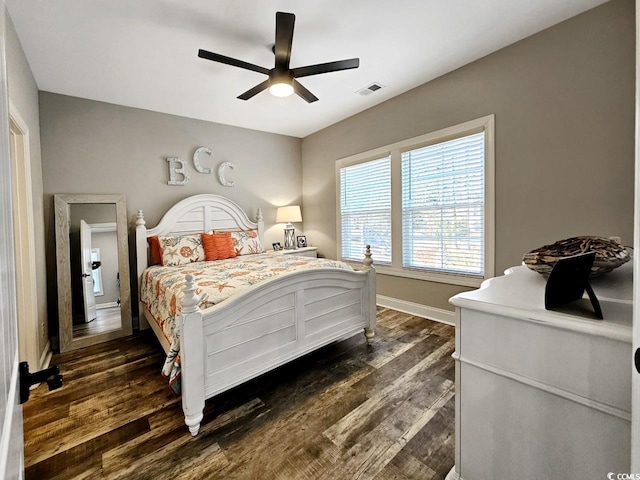 bedroom featuring dark wood-type flooring, visible vents, ceiling fan, and baseboards