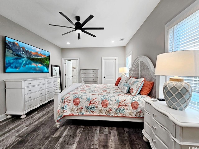 bedroom featuring dark wood-type flooring, multiple windows, and visible vents